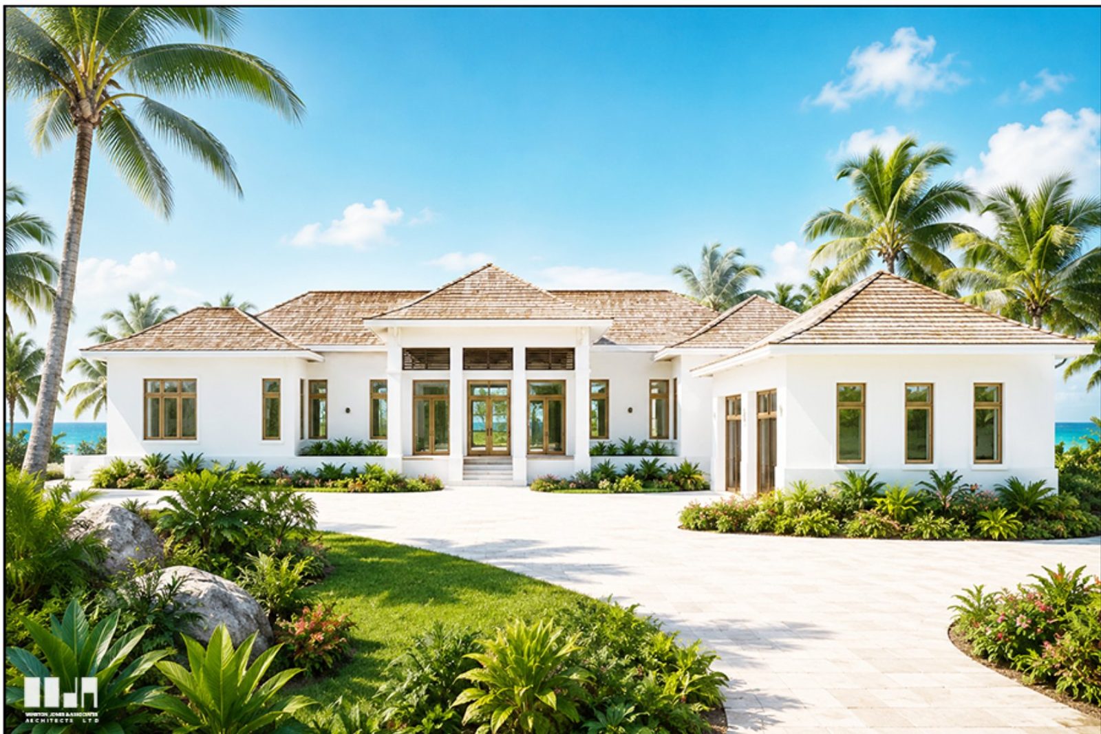 A single-storey white house with hipped shingle roofs and a columned entry, set behind a paved drive and tropical planting, with the sea beyond.