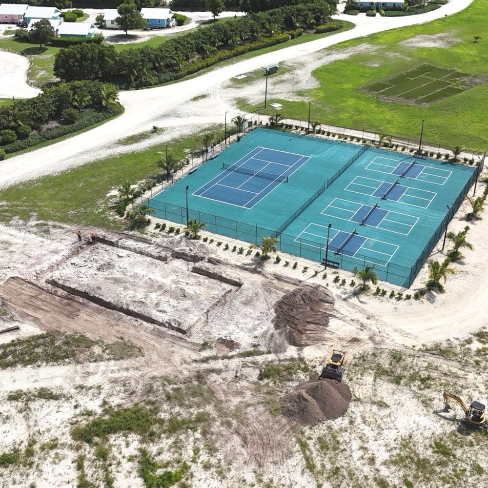 Aerial view of the cleared fitness center site beside the tennis and pickleball courts