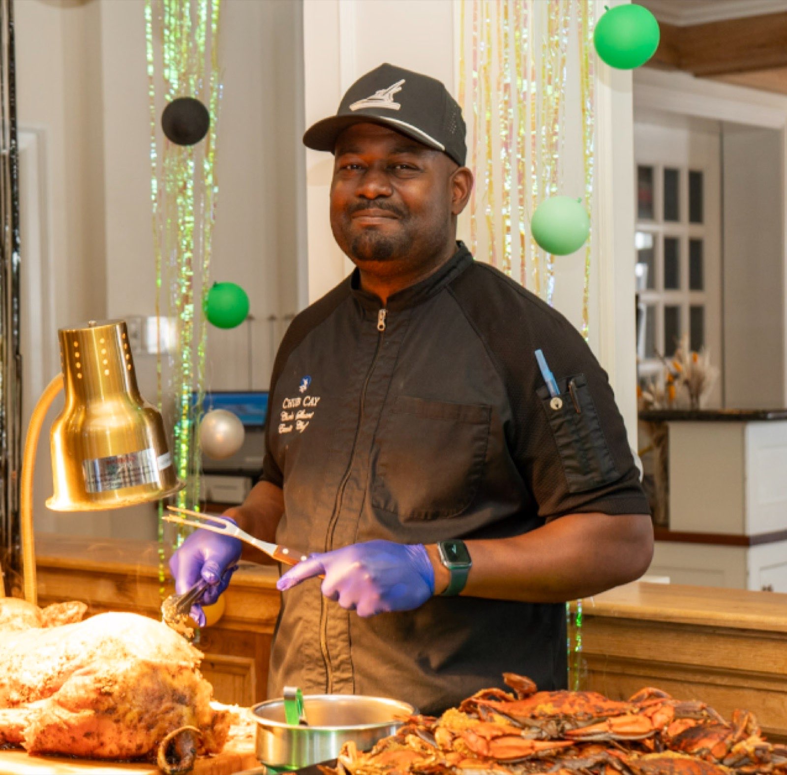 Executive Chef Charles carving at a buffet station with crabs and roasted turkey